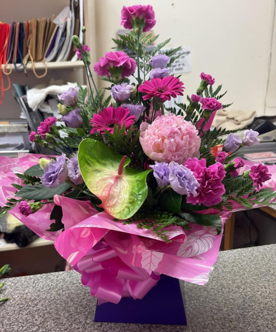Pink Flourish - A striking front-facing bouquet in rich pink and soft purple tones, complemented by fresh greenery.