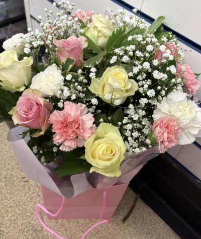 Sweet Serenity - A delicate arrangement of soft pink, cream and white tones, finished with fresh greenery and dainty white accents.
