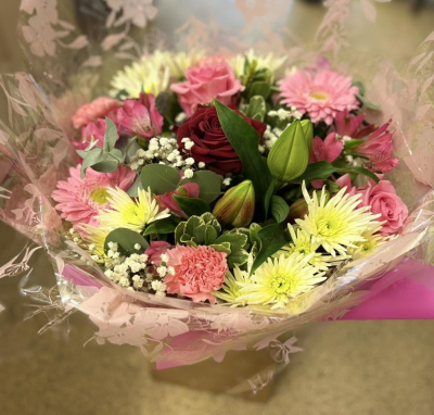 Rosy Delight - A charming bouquet of soft pinks, deep rose and fresh cream tones, beautifully complemented by lush greenery.